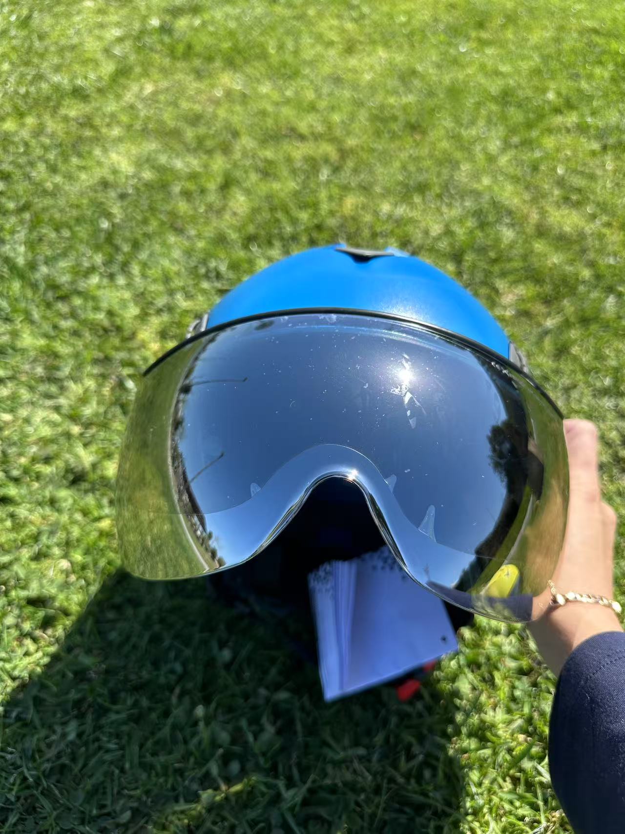 Low angle of blue AeroPro Safety Helmets with Smoke Visor Kit on Grass. ANSI/ISEA Z89.1-2014 Type 1 Class C Safety Helmet with Smoke Visor used for Construction, Rescue & Arborist.